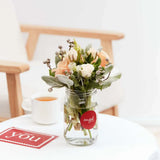 Stunning fresh flowers in a clear vase on a table.