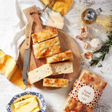 Fresh bread served on a wooden board with butter.